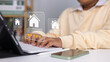 © Thawatchai Images - Real estate review rating concept showing businessman using digital pen on laptop to give property five-star rating, smart technology, online service, feedback system, home buying, housing evaluation.