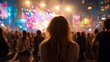 © mbah - A woman with flowing hair watches a vibrant stage show at night