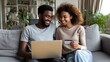© Johannes - young happy couple using laptop and credit card while shopping on the internet at home  no logos no brands ar 169