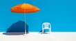 © Shah Putra - Bright orange umbrella with white chair