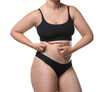 © New Africa - Liposuction. Woman in underwear touching her belly on white background, closeup