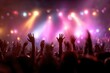 © Iftikhar alam - Vibrant concert crowd with raised hands celebrating a night of music, surrounded by colorful lights and an electrifying atmosphere