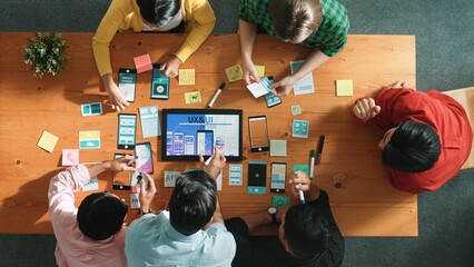 top view of software developer writing idea about ux ui design for mobile phone interface. programme