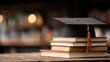 © Nahida - High definition photo of close-up of a graduation cap resting on a stack of books, symbolizing academic achievement and educational success.