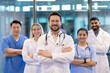 © Liubomir - A team of diverse healthcare professionals confidently smiling in a modern hospital setting. Showcasing teamwork and dedication in providing quality medical care and fostering trust with patients.