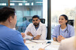 © Liubomir - Doctors and nurses engage in a focused discussion during a meeting at their workplace. The professional atmosphere highlights teamwork and communication amidst medical professionals