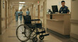 © Hamid - Empty wheelchair sits in hospital corridor, nurses walking in background, security guard at desk.