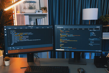 programming code on computer two screens on desktop placing working desk showing intelligent website