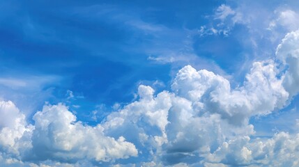 Wall Mural - Clouds forming majestic shapes in a brilliant blue sky on a bright sunny afternoon
