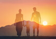 © kieferpix - silhouette of a family walking on the sunset