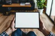 © EKAN KUDAH - Man holds blank tablet, home living room, cozy background, mockup