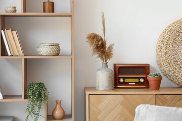 Poster - vase with pampas grass and retro radio receiver on drawers in room