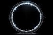 © btiger - Shining circular ring made of sparkling silver glitter against a black background creating a glowing halo effect