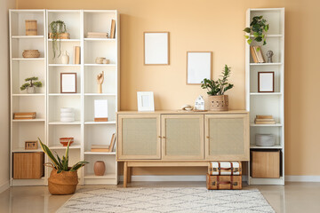 Poster - interior of living room with dresser and shelving units near beige wall