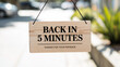 © Naseem - Back in five minutes sign business message shop store notice board patience