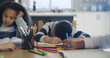 © peopleimages.com - Bored, tired and children for education at house for learning, group project and homework burnout. Exhausted, kids and study fatigue with exam pressure, academic problem and laziness for assignment