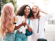 © halayalex - Three young beautiful smiling hipster female in trendy summer clothes.Sexy carefree multiracial women posing on the street background. Positive models having fun