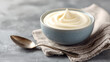 © Rohan Katwe - Creme Fraiche. Delicious whipped cream served in a bowl, on rustic wooden table for a delightful dessert presentation.