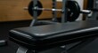 © Zhanna - Weight bench in modern gym with barbell equipment in background