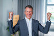© BusinessClass by W61 - Happy successful senior businessman cheering in office