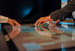 © BusinessClass by W61 - Hands collaborating on futuristic touchscreen technology in modern office