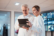 © BusinessClass by W61 - Medical professionals collaborating on tablet in modern clinic