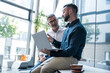 © BusinessClass by W61 - Manager consulting colleague with tablet in modern office