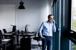 © BusinessClass by W61 - Smiling businessman talking on mobile phone near window in office