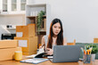 © NINENII - Woman start up online seller owner at workplace.