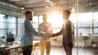 © ryker - Business professionals shaking hands in modern office setting, symbolizing collaboration and partnership. warm sunlight creates positive and inviting atmosphere