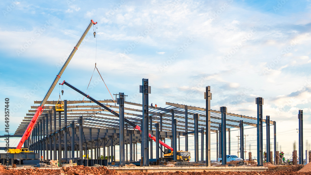 Large factory industrial building framework with workers and crane ...