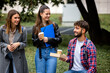 © Mediteraneo - Students Laughing with Books and Coffee on College Campus