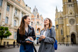 © Mediteraneo - Two Female Students with Books on College Campus