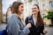 © Mediteraneo - Two Friends Laughing and Talking in City Center