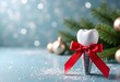 © Olga - Dental implant decorated with red bow on christmas background