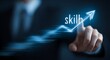 © Iffatjahan - Businessman's hand points to glowing upward trend graph with the word skill growth development
