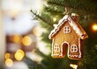 © Luqman - Close-up of a gingerbread house ornament hanging on a Christmas tree, with blurred lights in the background. Charming home decor for the holiday season. Shallow depth of field with a bokeh effect. Sto