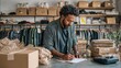 © Attasit - Boutique shop owner scanning items and marking inventory on checklist, opened packages and clothing racks in background, focused and organized