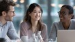© Puhnnawit - Group of three professionals from diverse ethnicities collaborating around a sleek office table with soft daylight, friendly expressions, and teamwork in a modern workplace