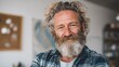 © Johannes - smiling relaxed mature older bearded hipster man looking at camera happy handsome confident middle aged 50s male professional standing at home office posing indoors for close up headshot portrait no