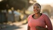 © Johannes - plus size african woman smiling at camera while doing running routine outdoor  soft focus on face no logos no brands ar 169