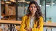 © Johannes - young smiling latin girl college student or teacher looking at camera standing in university campus happy hispanic millennial woman professional posing in modern coworking creative office space no lo