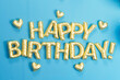 © Rendara Studio - 3D golden balloons spelling happy birthday on blue background