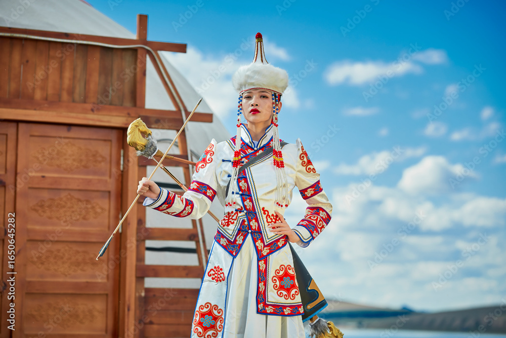 Mongolian girls dressed in traditional Mongolian attire and holding ...