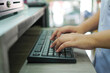 © Nattawat - Hands typing on keyboard at pharmacy counter