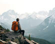 © jamal - A man with an orange backpack sits on a rock looking out at a mountain range on a cloudy day in nature