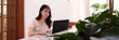 © snowing12 - Asian young adult woman freelance professional remote work modern cafe natural light environment laptop computer technology business productivity lifestyle