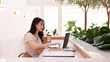 © snowing12 - Asian Adult Woman Freelancer Remote Work at Modern Cafe Using Laptop Computer for Business Productivity Flexible Lifestyle