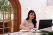 © snowing12 - Asian young adult woman freelancer works laptop notebook cafe remote professional online business creative writing digital nomad modern workspace