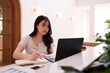 © snowing12 - Asian adult woman freelancer remote work modern cafe environment productivity focus laptop notebook business professional